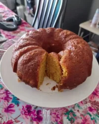 Slice of classic vanilla layer cake on a vintage floral plate