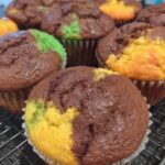 Vintage wire cooling rack holding colorful cute cake cupcakes