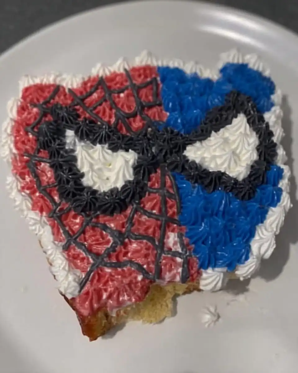 Spider Man Cake 13 Process shot of cutting white and black fondant eyes with a knife
