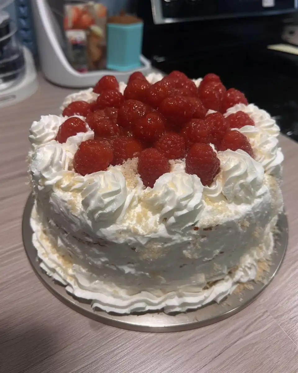 A slice of decorated white cake served on a dessert plate