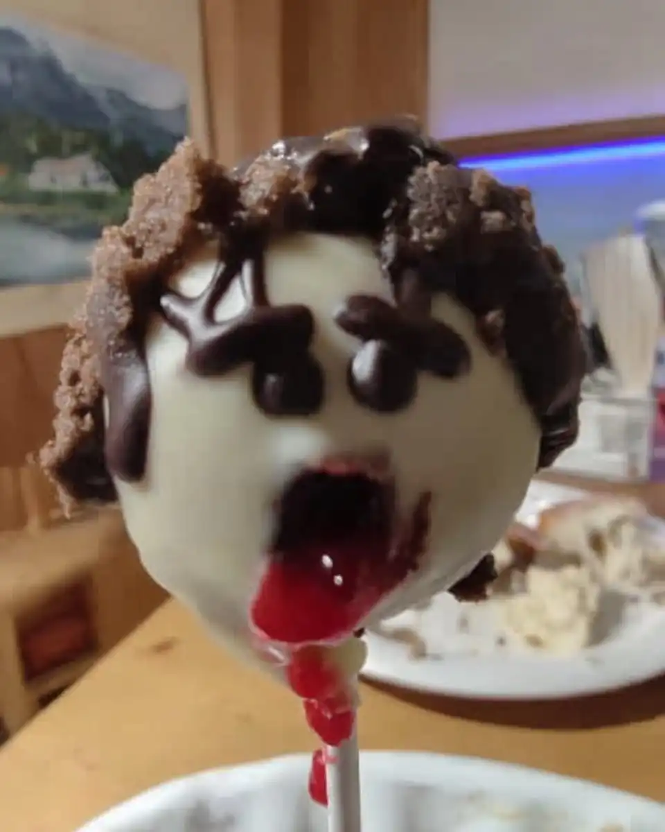 Dipping a cake ball into melted chocolate