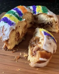 Golden brown King Cake decorated with purple green and gold sugar