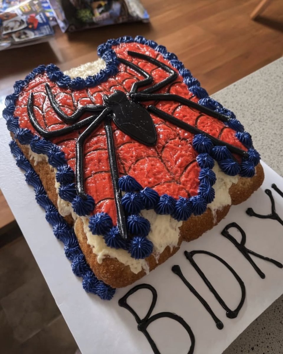 Slice of spider man cake on a plate with webbing decoration