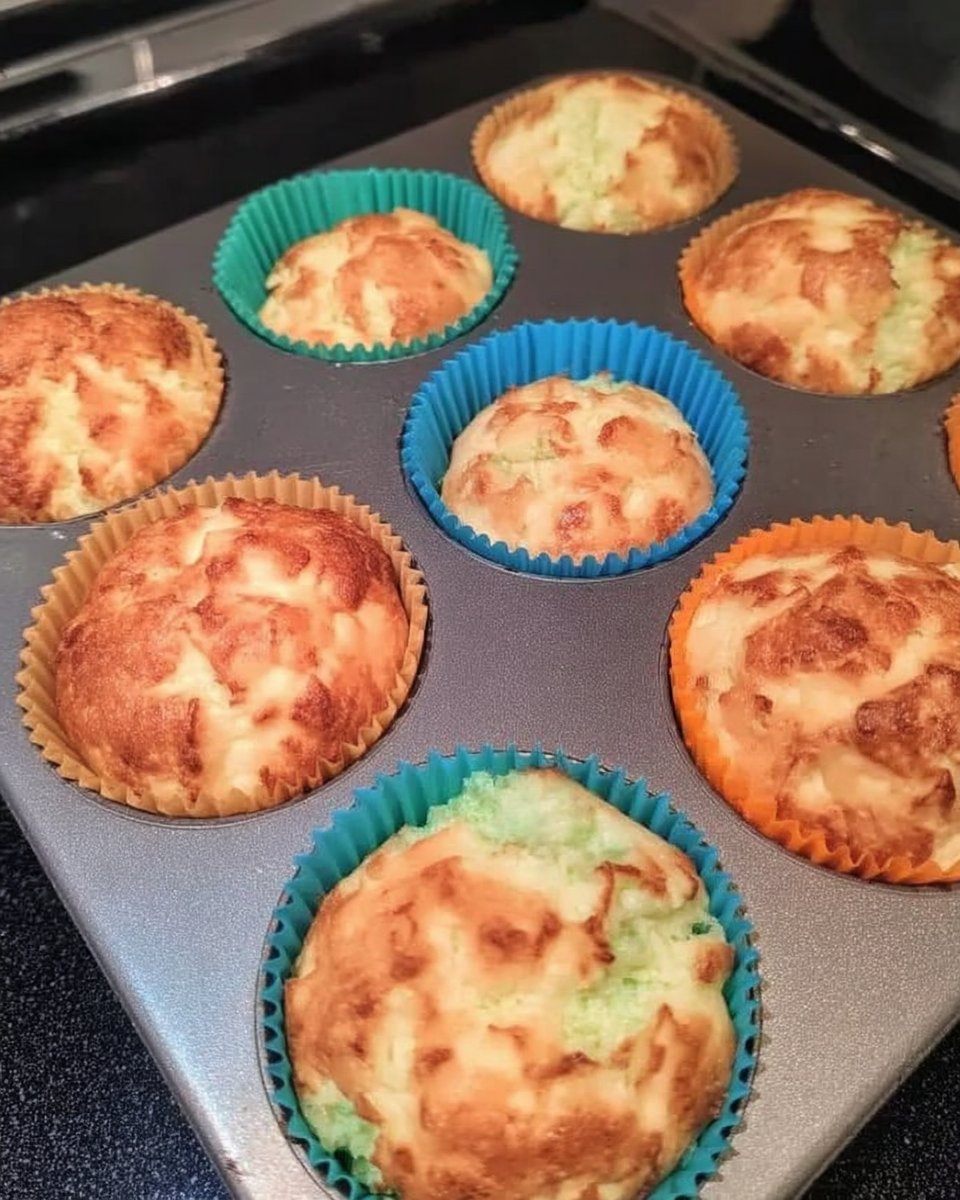 Spatula gently folding whipped egg whites into pink cake batter