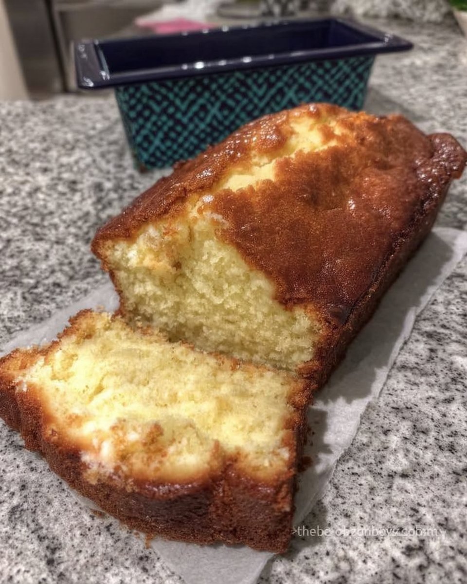 Fresh lemons and a bowl of sugar on a wooden table