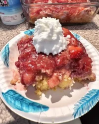 Slice of fresh strawberry sheet cake on a vintage floral plate with a silver fork