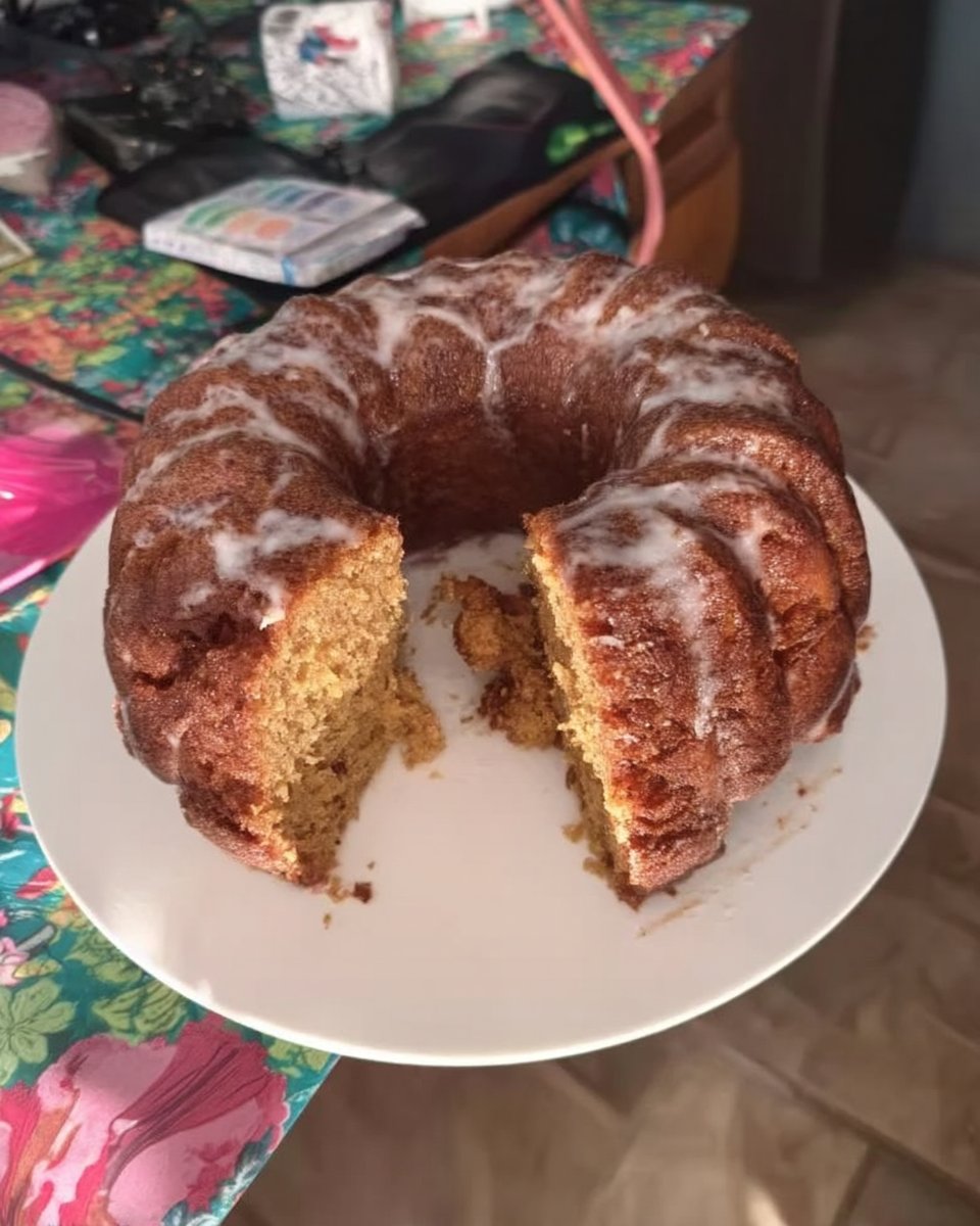 Whole frosted vanilla cake with chocolate frosting and colorful sprinkles