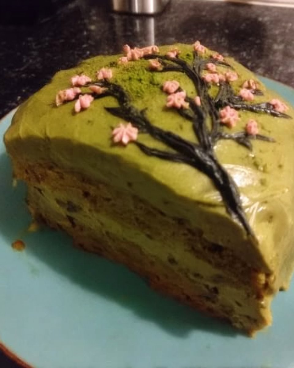Bowls of green tea powder flour and eggs on a wooden table
