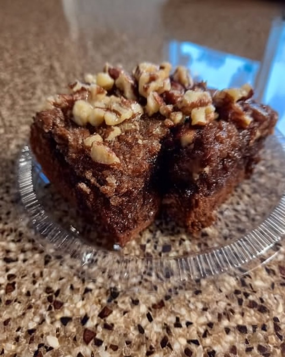 Baking ingredients including cocoa powder buttermilk butter and pecans on a wooden table
