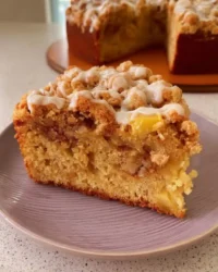 Slice of Irish Apple Cake with streusel topping and cinnamon glaze