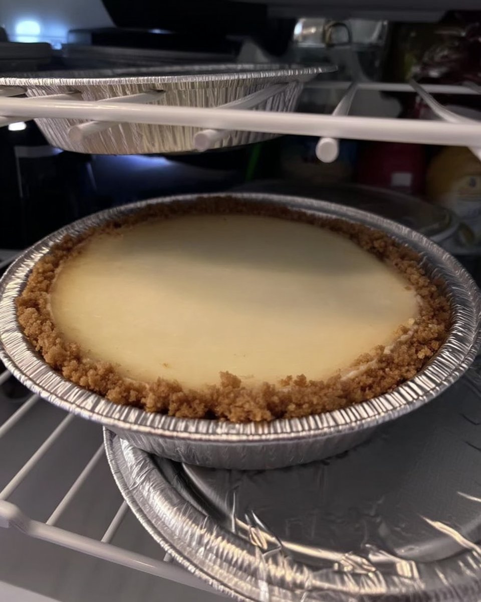 Foil wrapped cheesecake pan in a water bath