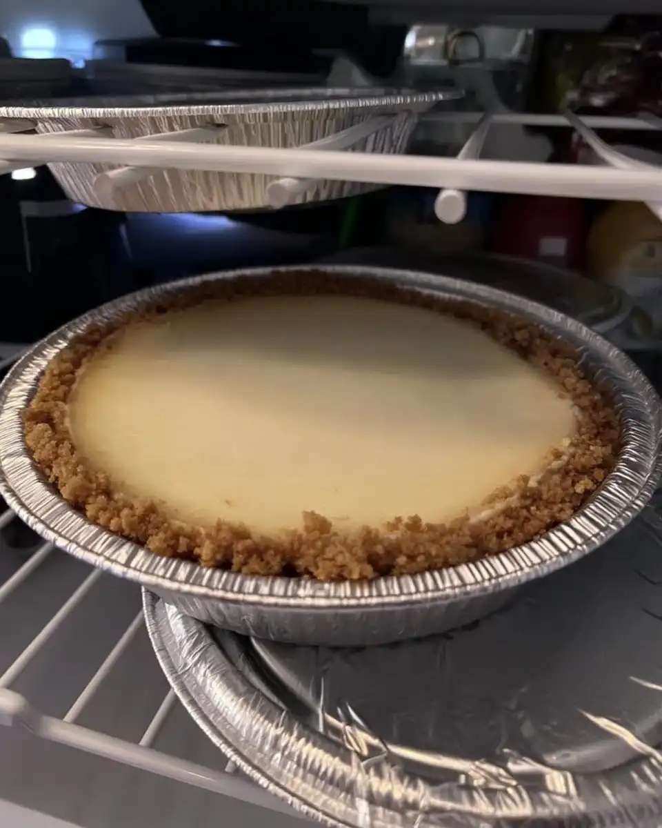 Foil wrapped cheesecake pan in a water bath