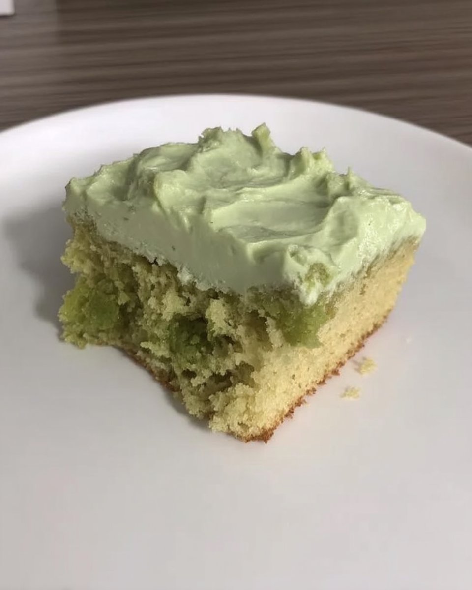 Mixing the green pistachio cake batter in a bowl