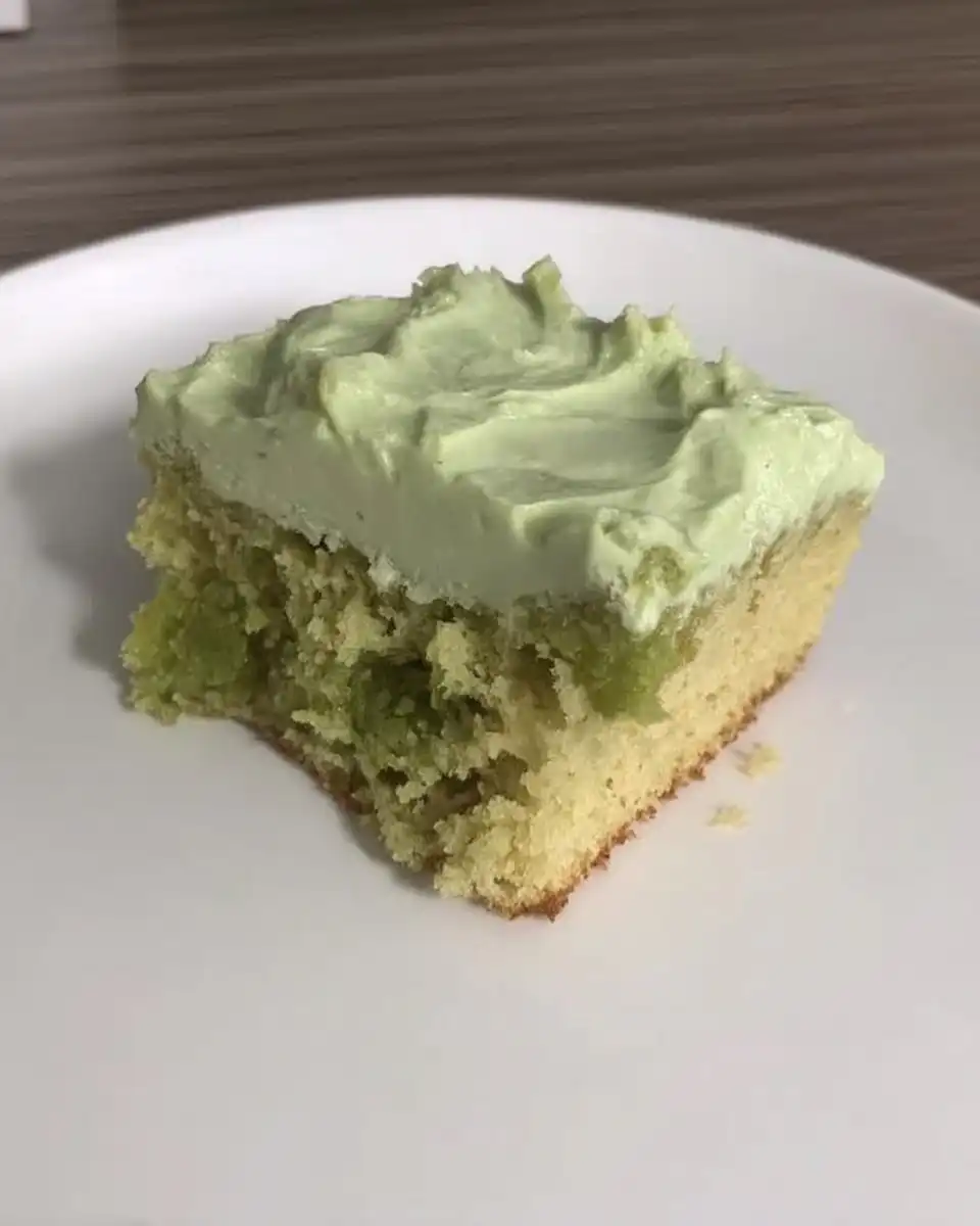 Mixing the green pistachio cake batter in a bowl