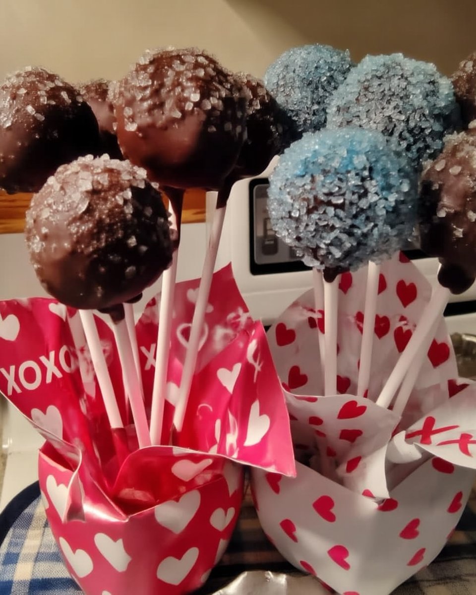 Slice of moist chocolate cake on a plate with glossy frosting
