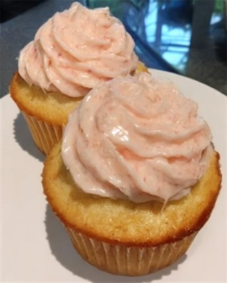 Slice of vintage pink champagne cake on a floral china plate with a fork