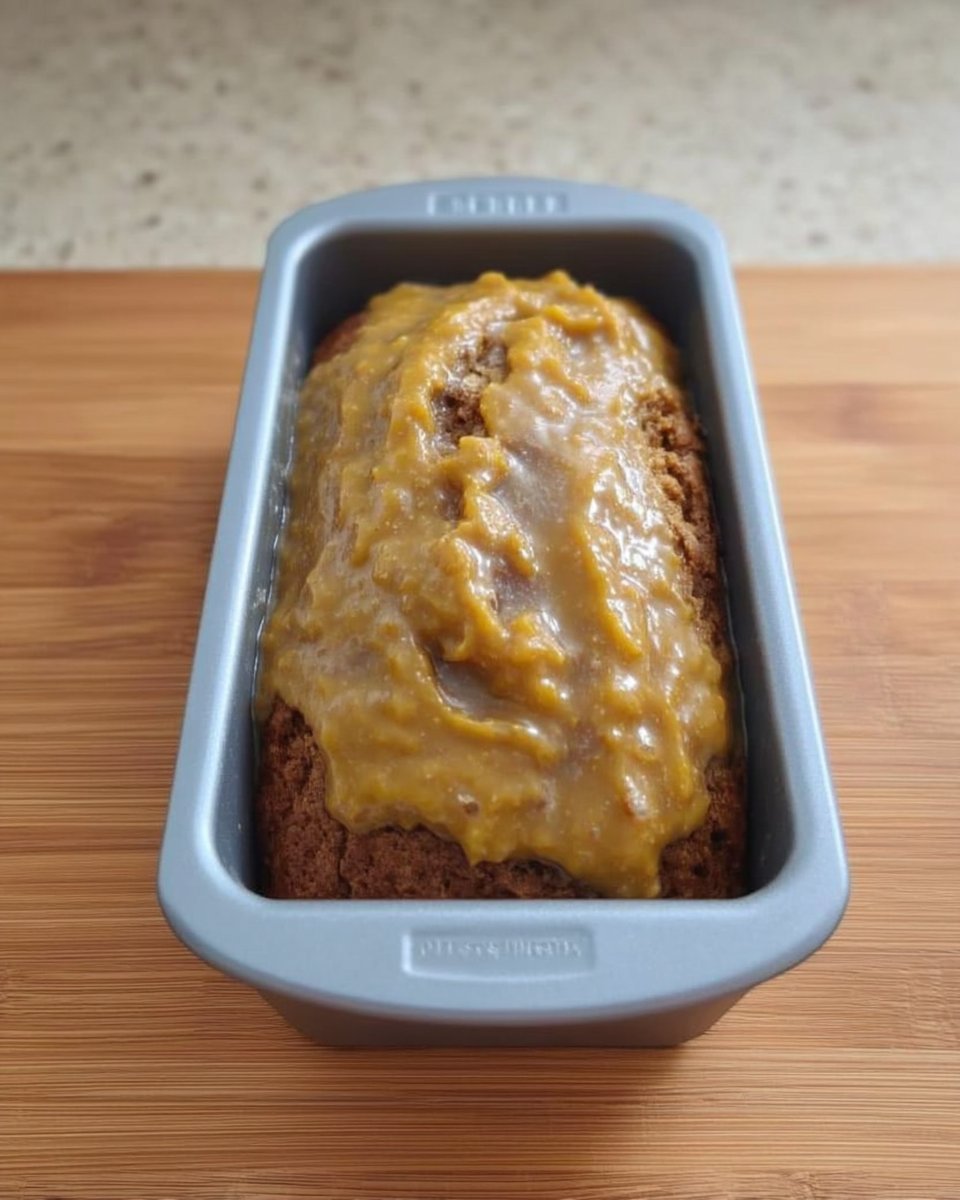 Close up of raisins soaking in warm water in a small ceramic bowl