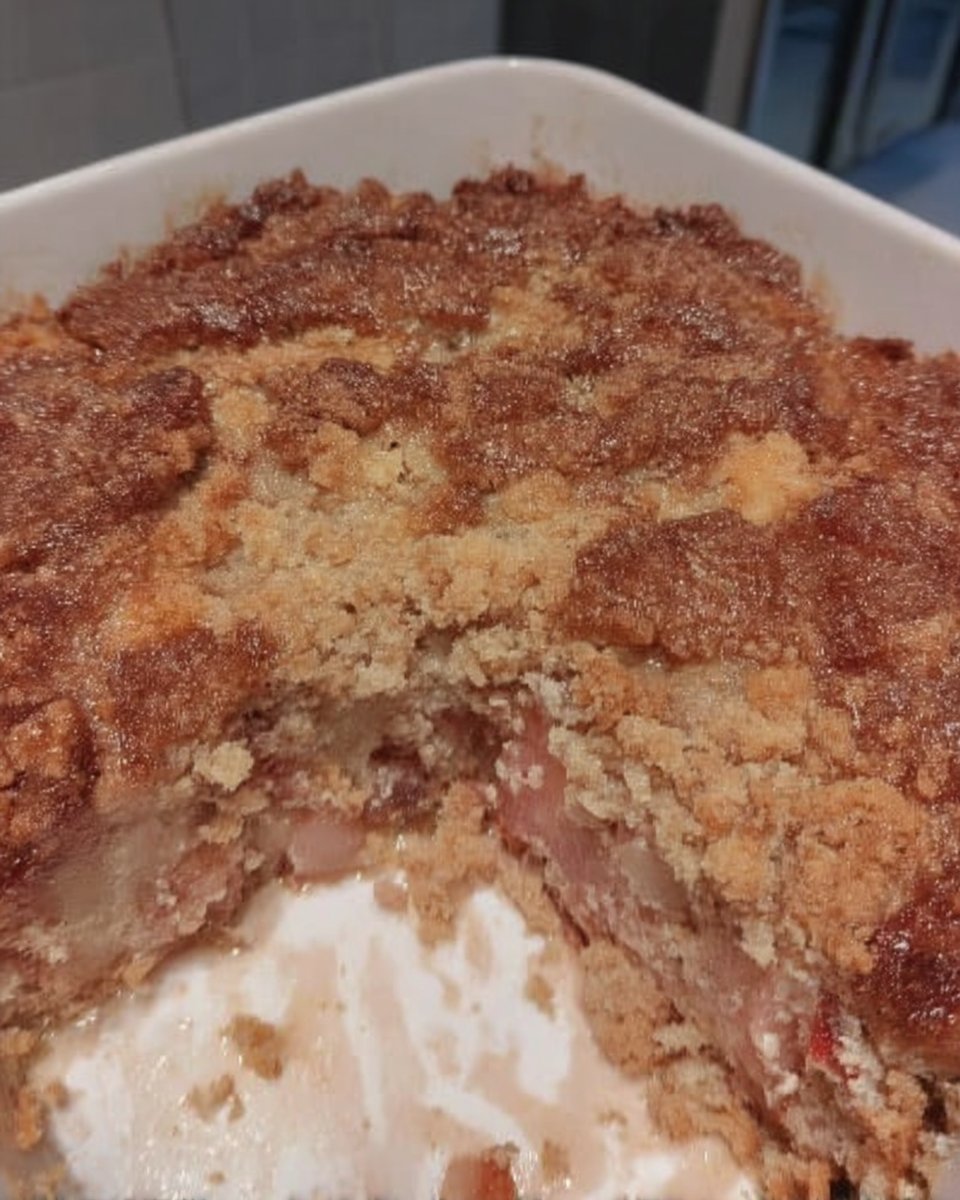 Strawberry Rhubarb Cake 13 Pouring milk and butter glaze over a poked strawberry rhubarb cake