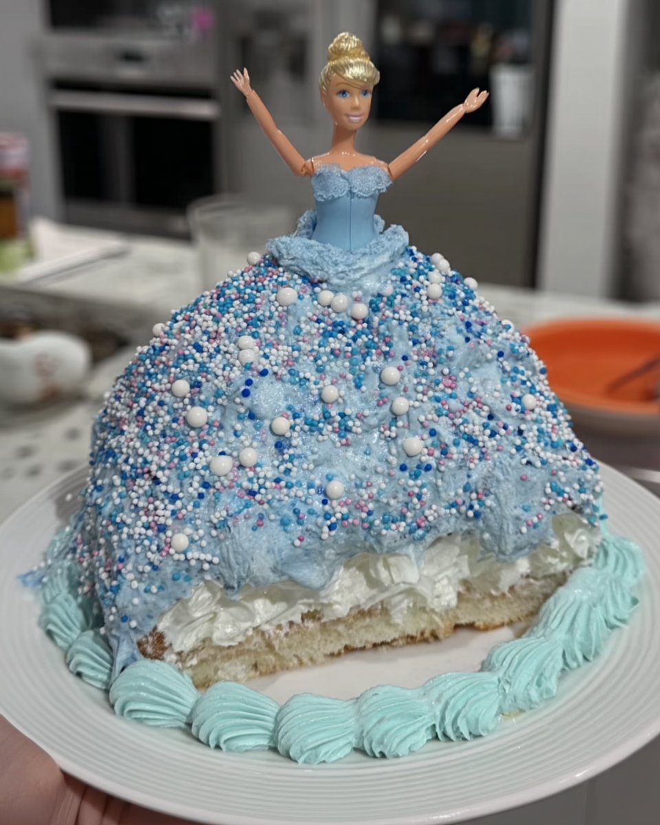 Slice of blue tsunami cake with sprinkles on a vintage plate
