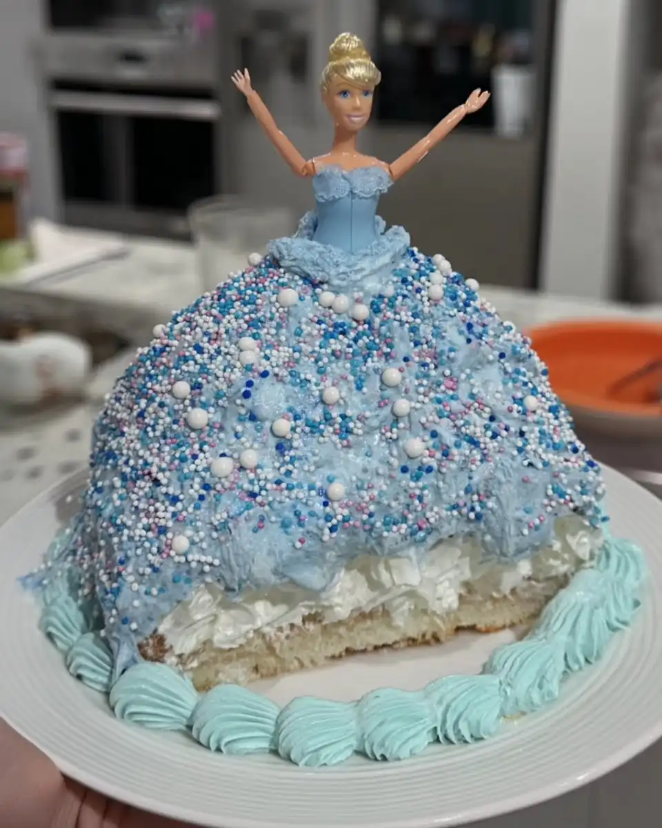 Tsunami Cake 14 Slice of blue tsunami cake with sprinkles on a vintage plate