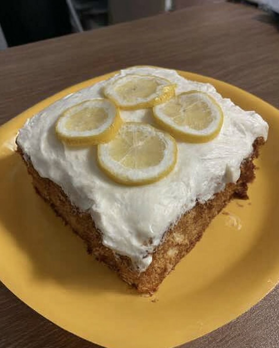 Whole vintage lemon cake on a glass stand sitting on a grandmothers lace tablecloth