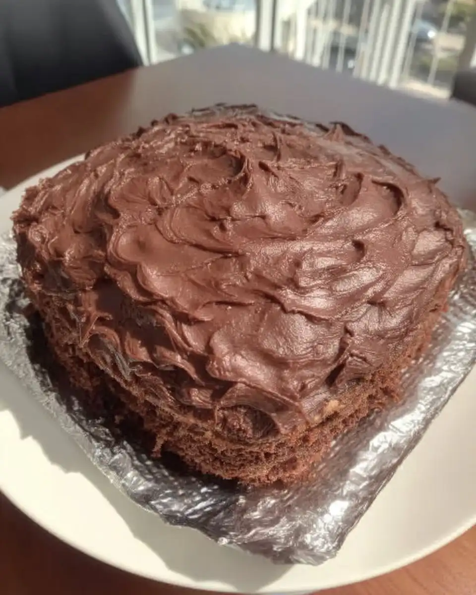 Baked wacky cake in pan dusted with powdered sugar