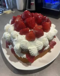 A slice of white almond sour cream cake with fluffy white buttercream frosting
