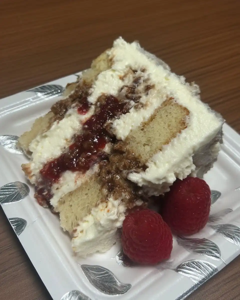 Whole raspberry white chocolate cake decorated with fresh berries