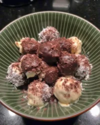 Golden cake pops dipped in chocolate on a stick