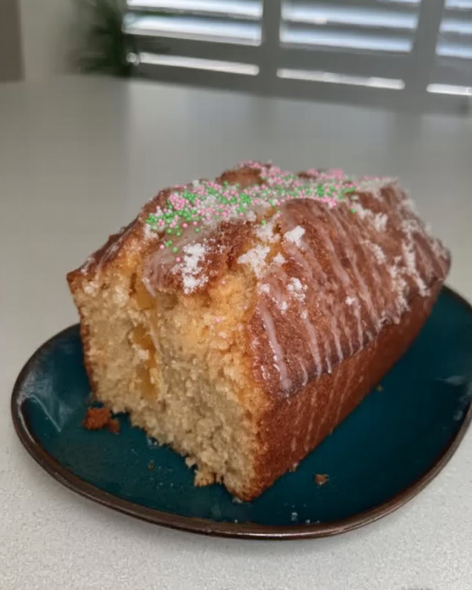 Hands zesting a lemon into a bowl of white sugar