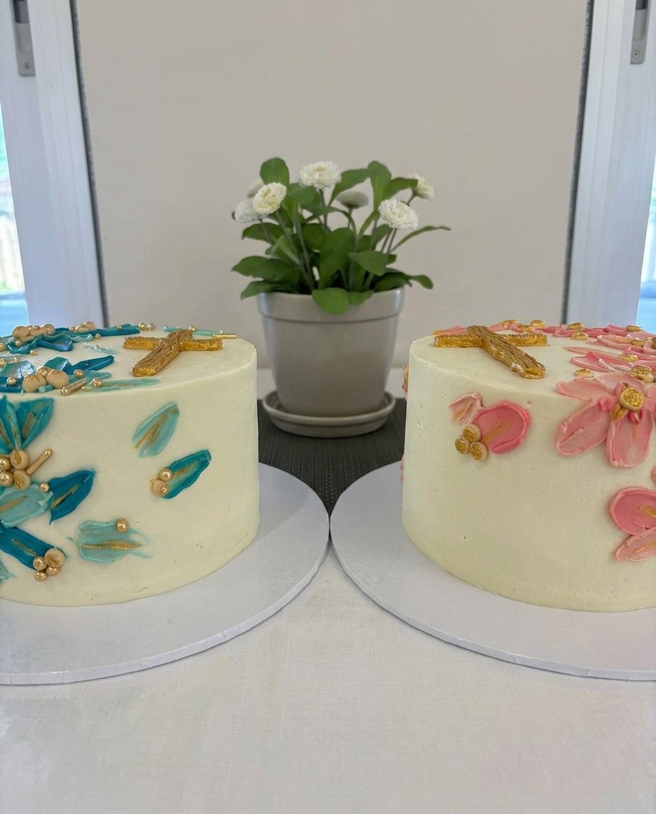 A slice of white cake with buttercream on a floral china plate