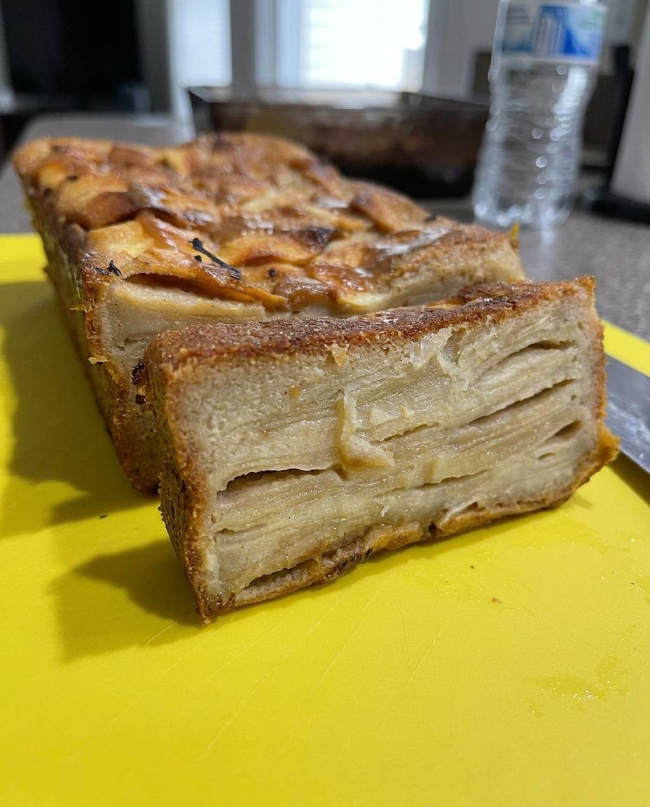 Thin pats of butter covering a layer of dry spice cake mix in a pan