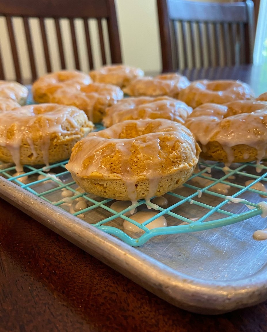 A decadent chocolate donut cake with a glossy white vanilla glaze dripping down the sides.