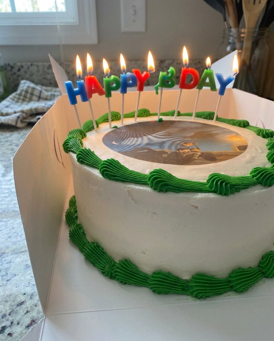 A smooth cheesecake topped with a custom edible photo and a graham cracker crust