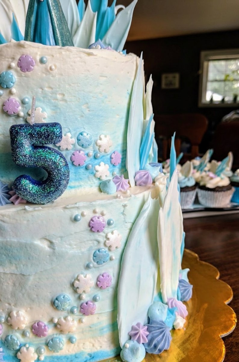 Translucent blue sugar glass pieces shaped like castle walls on a cooling rack.