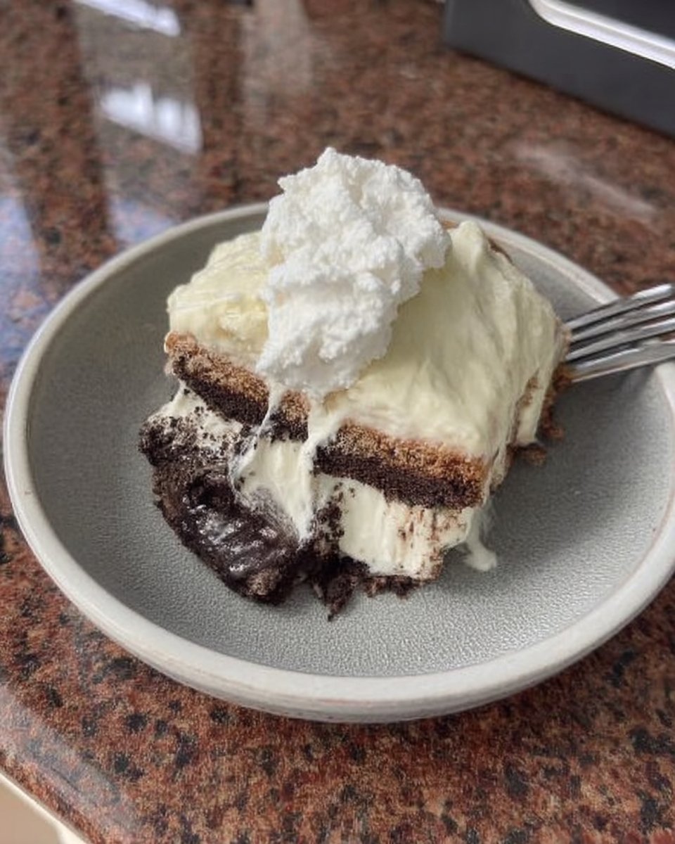 Fresh heavy cream, vanilla beans, and Oreo cookies on a marble surface