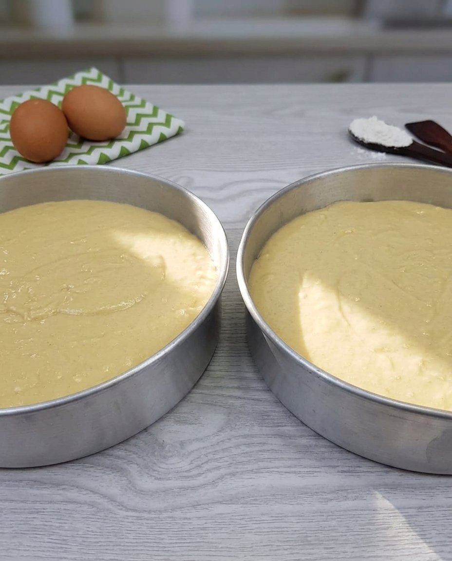 Ingredients for a homemade chocolate cake including cocoa powder, buttermilk, and dark chocolate.