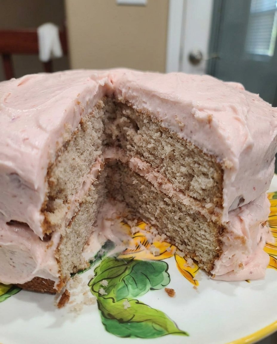 Fresh strawberries, flour, eggs, and butter arranged on a wooden kitchen table