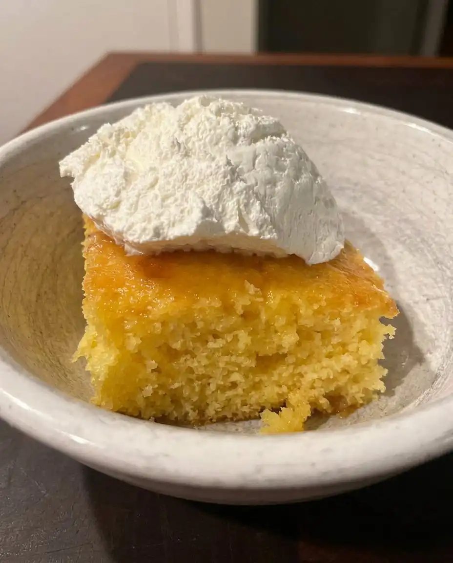 Ingredients for lemon poke cake including fresh lemons, eggs, and cake mix on a rustic table