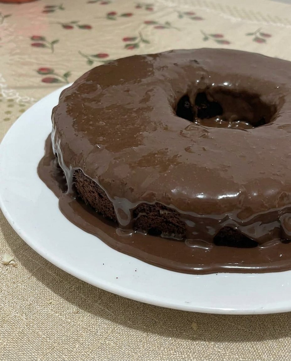 Two round dark chocolate cake layers resting on wire cooling racks