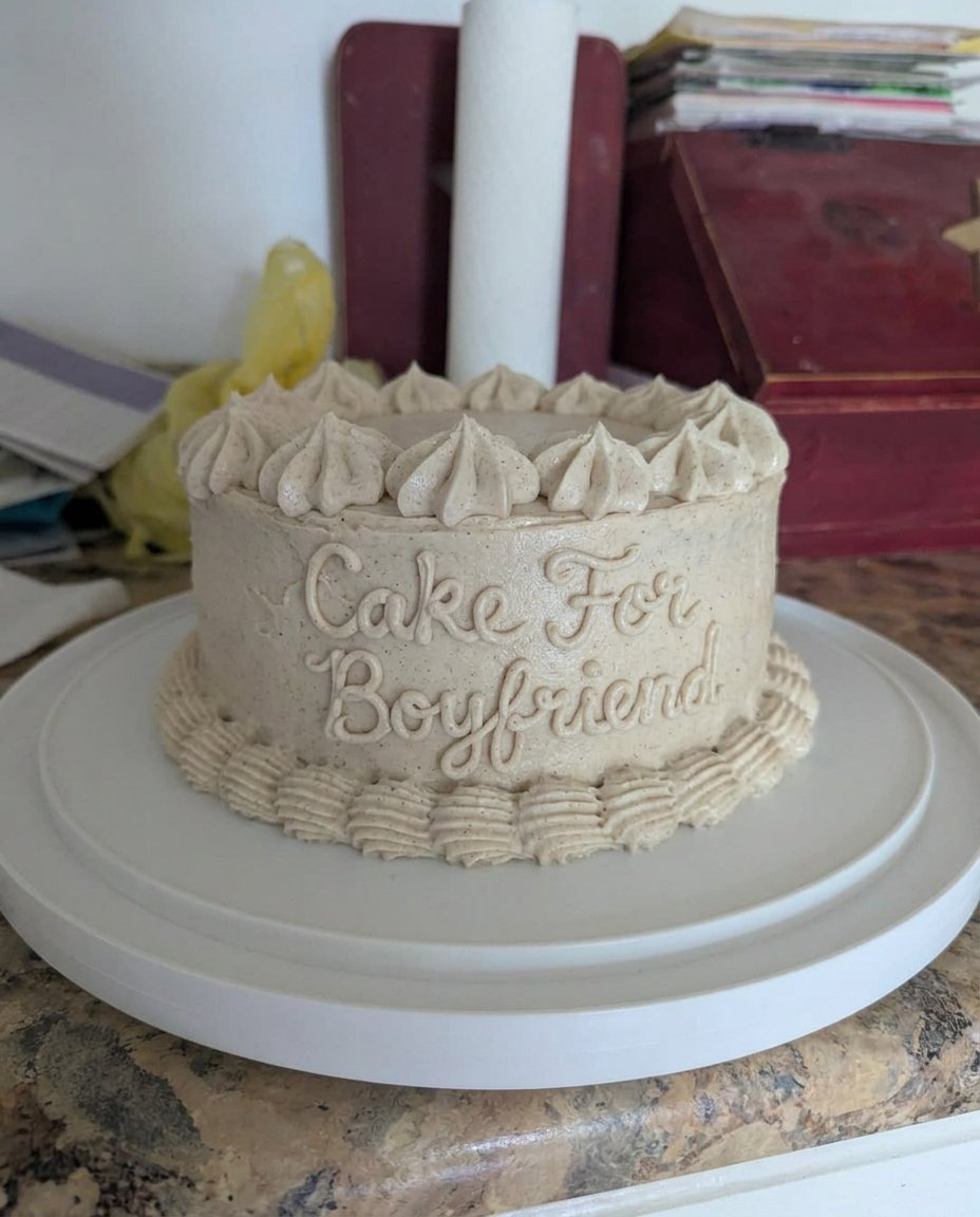 A single slice of chocolate cake on a white plate with chocolate syrup