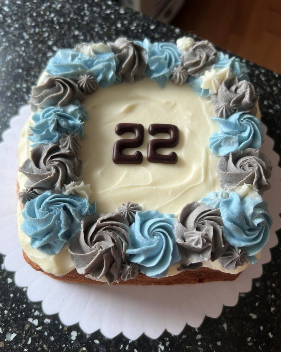 A slice of ombre cake served on a fine china plate with blueberries
