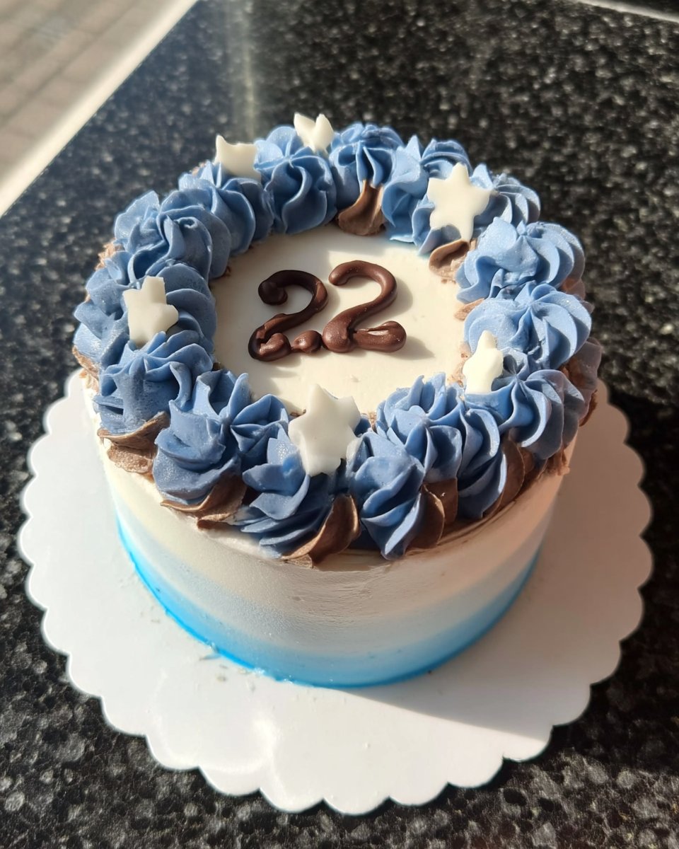 A pastry chef using a bench scraper to smooth coconut buttercream