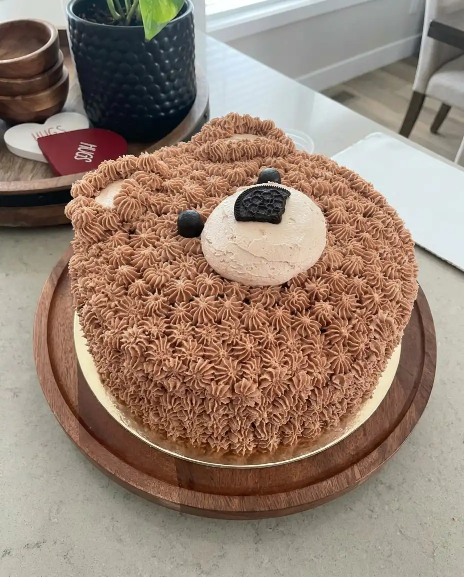 A slice of chocolate bear cake on a white plate showing the internal layers.