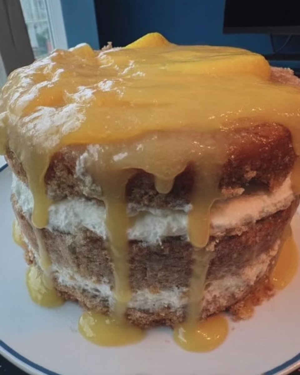 A slice of Lemon Rainbow Cake 2 on a delicate china plate with a fork