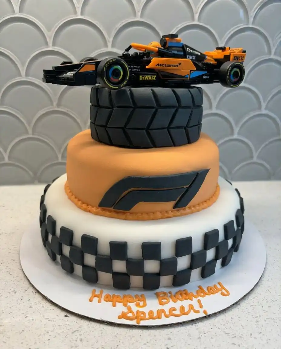 F1 cake served on a grey board with chocolate sprinkles representing asphalt