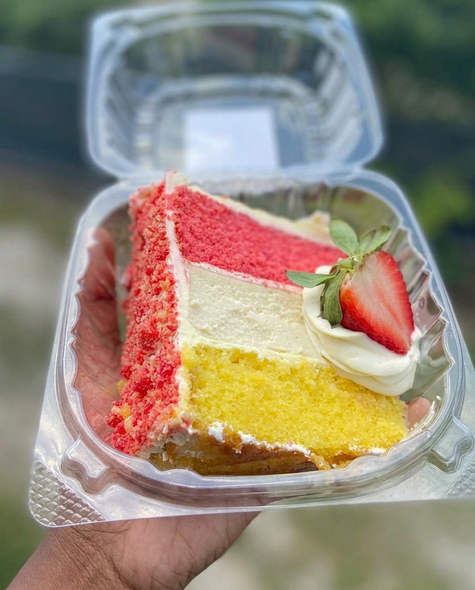 Carrot Cake Slice 14 A carrot cake slice served next to a steaming cup of tea in a vintage teacup