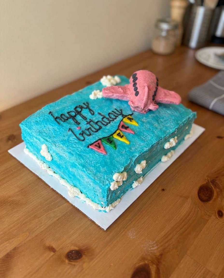 A square slice of chocolate chip rectangle cake served with a glass of milk