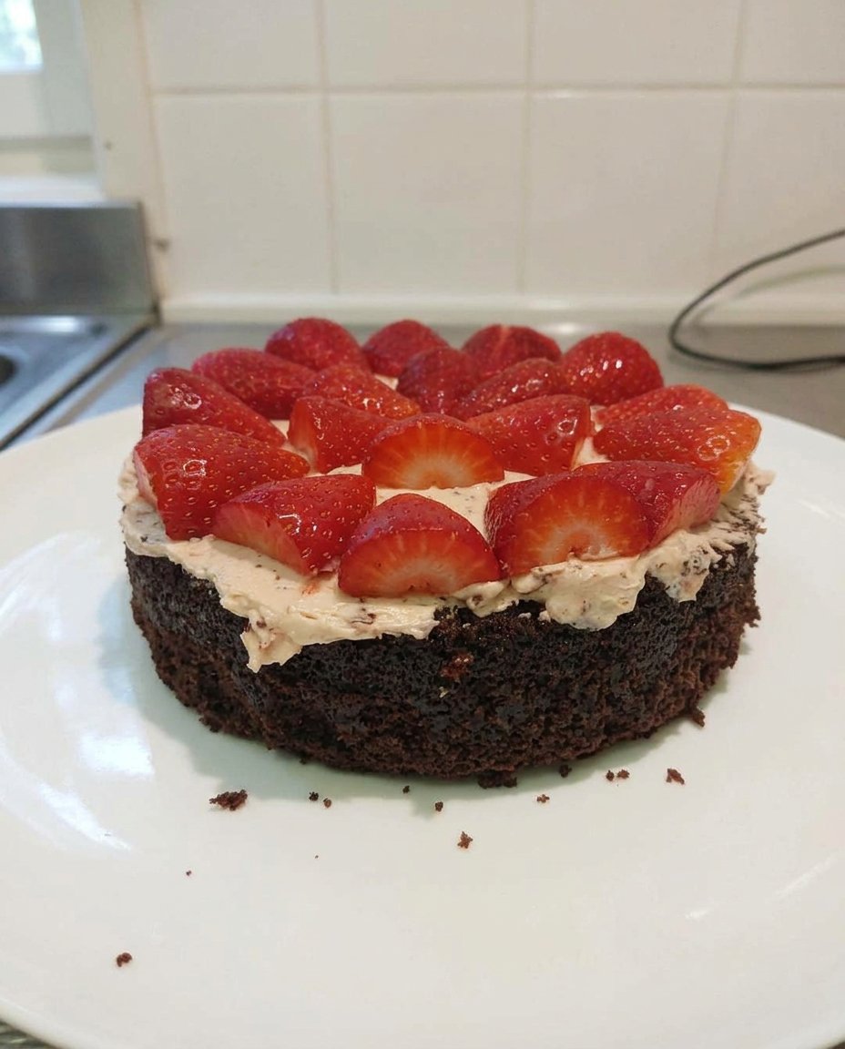 A hand sifting cocoa powder into a white ceramic bowl