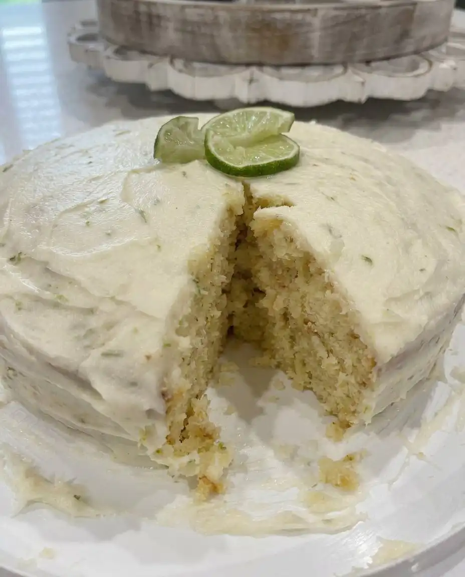 A single square slice of key lime cake on a fine china plate